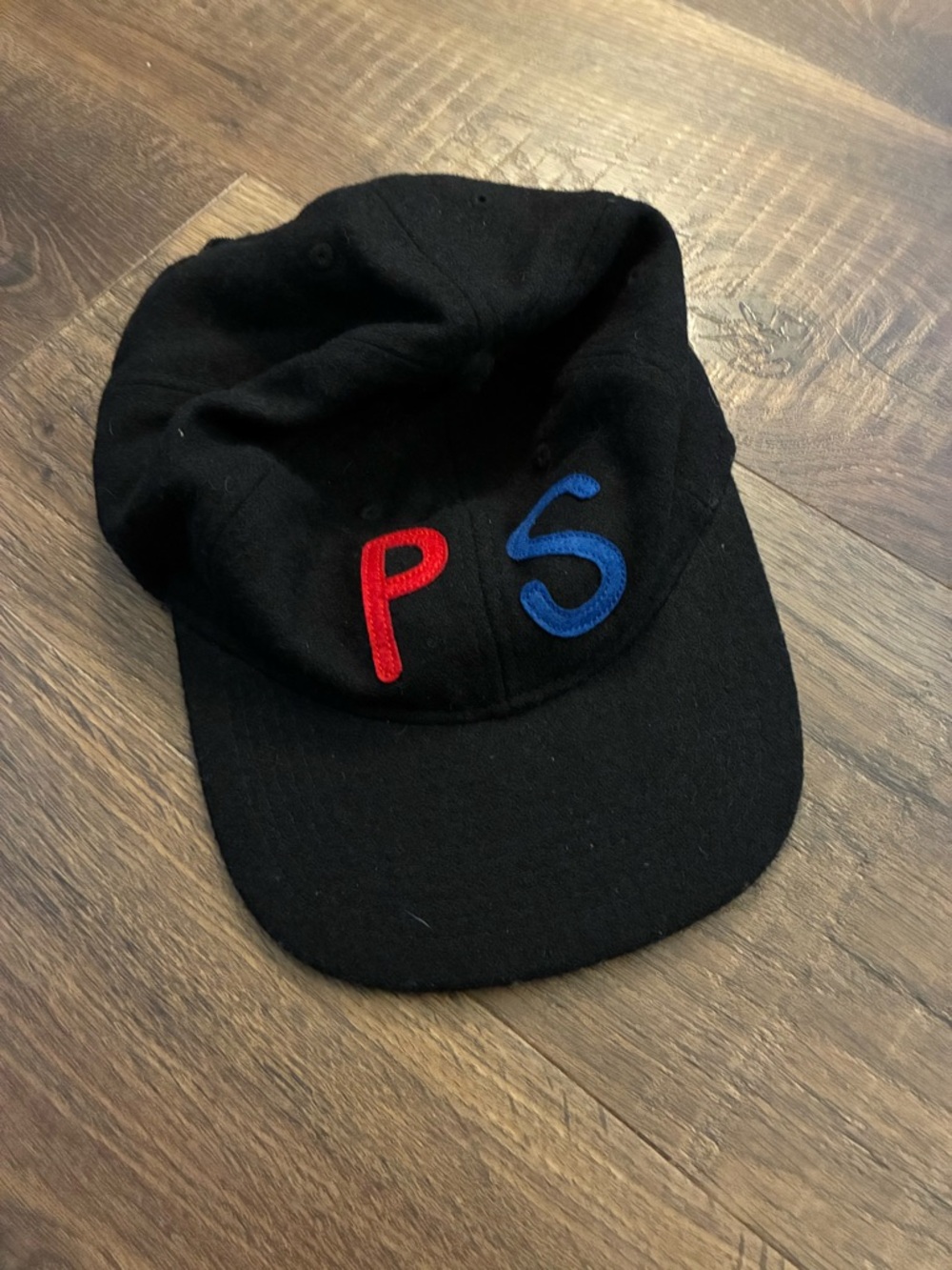 Black Baseball Cap with Red 'P' and Blue 'S' Embroidery